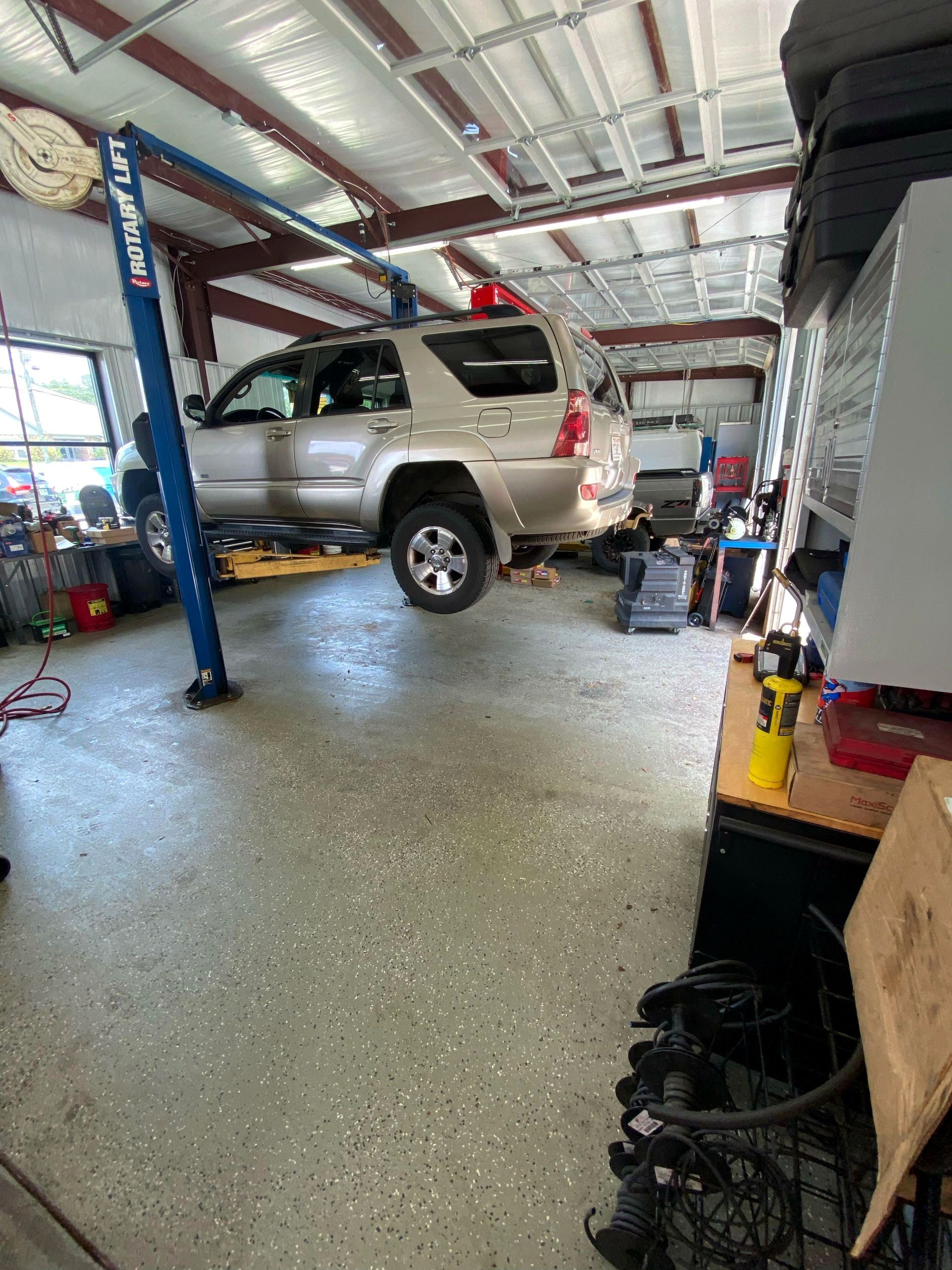 Toyota 4Runner up on a Rotary lift in the Pitt's Automotive service bay