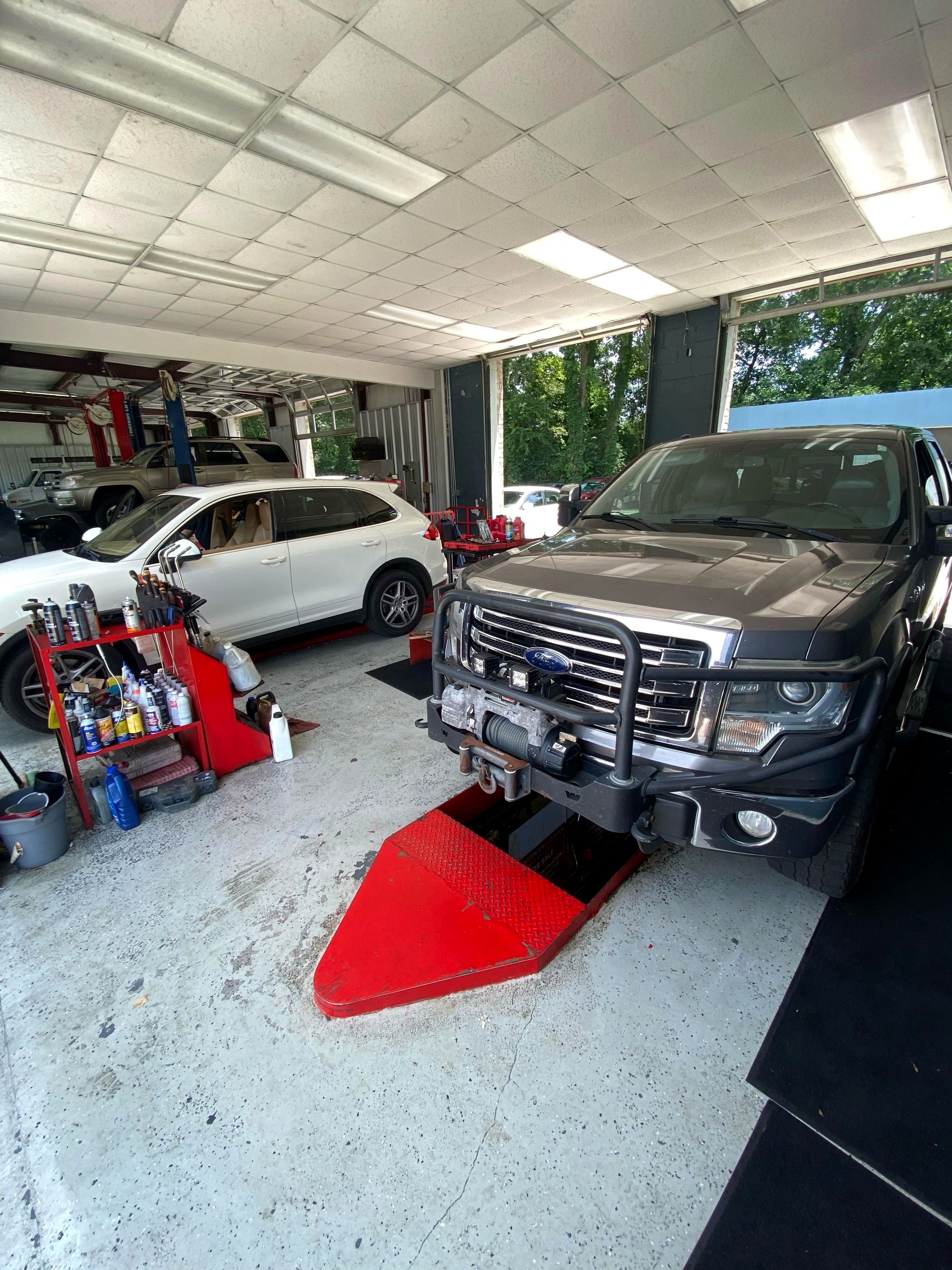 Pickup trucks in the Pitt's service bays under work